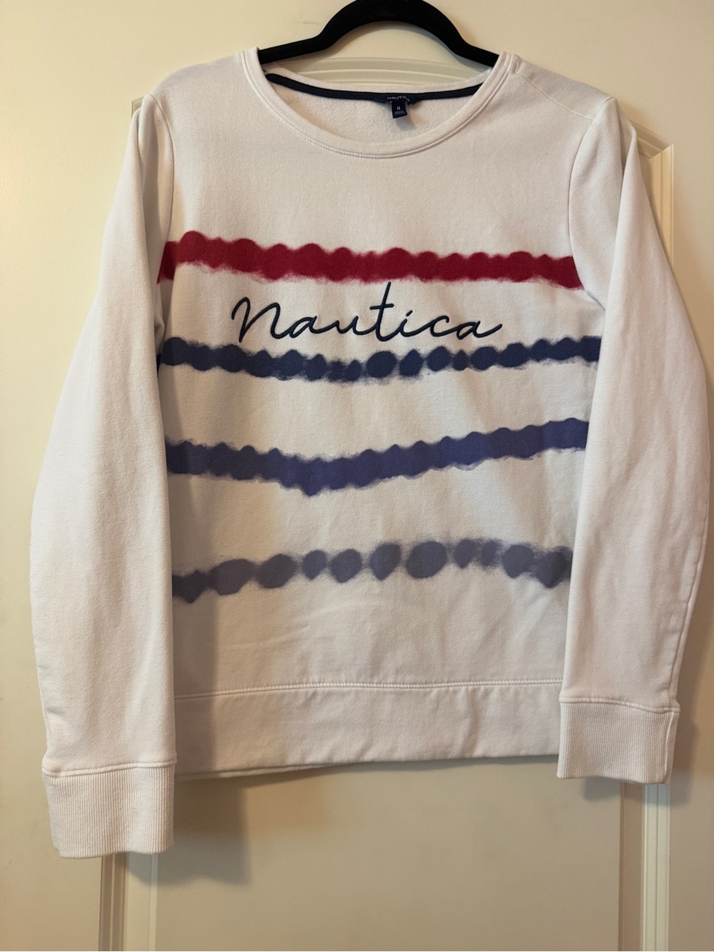 Women’s White Embroidered Nautica Crewneck Sweatshirt with Red and Navy Stripes.
